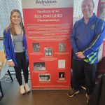 Freya Redfearn Badminton Player standing in front of a Badminton Museum Banner with Mike one from the Badminton Museum Board